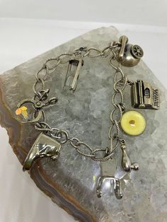 "Vintage sterling silver charm bracelet with eight sterling silver charms an hour glass, chair, shoe, type writer, mustard seed, scissors, bowling pin, and phone. Four charms are stamped silver and I believe the other four are also sterling silver. The mustard seed charm is inscribed on the back \"Amulet of faith, if ye have faith as a gram of mustard seed, nothing shall be impossible unto you, Sterling, Matt 1720.\" Several charms stamped \"Danecraft.\" Bracelet measures 6.5\" long." Cheap Silver Bracelets With Vintage Charm, Cheap Vintage Charm Bracelet As Gift, Glass Chair, Meaningful Symbols, Matthew 17, Vintage Sterling Silver Charms, Vintage Charm Bracelet, Sterling Silver Charms, Bowling Pins