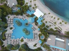 an aerial view of a resort pool and beach