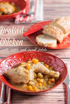 two red bowls filled with chicken and vegetables on top of a wooden table next to bread