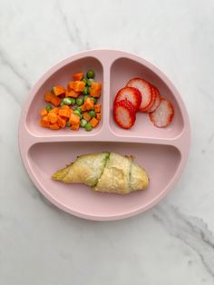 a pink plate topped with fruit and veggies