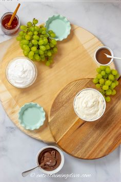 watermelon, grapes and whipped cream on a wooden platter