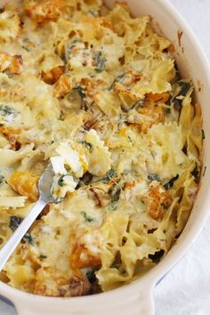 a casserole dish with spinach and cheese in it, ready to be eaten