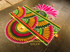 an artistically designed rangolite design on the ground for diwaling with lights