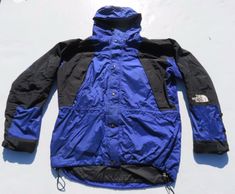 as seen. some imperfections. small tear on back. small stain on back and front.  mens large pit to pit 27" front collar to bottom 30" sleeve length center neck to end of cuff 36" Blue Nylon Parka For Outdoor Activities, Blue Nylon Outerwear For Camping, Blue Windbreaker With Double-lined Hood For Outdoor, Blue Nylon Parka With Detachable Hood, Blue Nylon Parka With Adjustable Hood, Blue Windproof Hooded Jacket For Hiking, Blue Windproof Hooded Jacket For Outdoor, Blue The North Face Windbreaker For Winter, Blue Parka With Adjustable Hood For Outdoor Activities