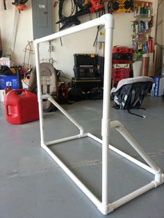 a white frame sitting in the middle of a garage