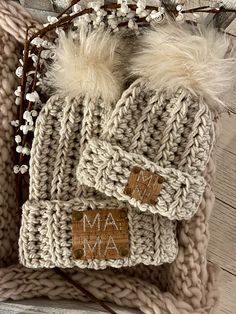 a knitted hat with two pom - poms on top and the word mama written