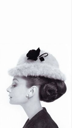 a woman wearing a hat with a bow on it