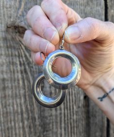 Gorgeous sterling silver hoop earrings, 1970s vintage. Features beautiful ridged silver circles with flat backs, a delicate ear hook with decorative ball, a bold yet easy-to-wear size, and lots of retro bohemian glamour... Easy to match and perfect for everyday wear, the silver sparkles perfectly when you move...;) Made in Mexico Stamped '925' for sterling silver 17 grams silver circles roughly 1.25 by 1.25 inches 2 inch drop (measure from the top of the hook to the bottom of the earring) Some minor silver tarnishing, and a little bending of the ear hooks (this does not affect wear, and could be carefully bent back as desired), but overall good vintage condition. Have a question?  Get in touch!  Always happy to talk. Bohemian Glamour, Retro Bohemian, Hippie Festival, Sterling Silver Hoop Earrings, 70s Vintage, Ear Hook, Sterling Silver Hoops, Jewelry Earrings Hoops, Silver Hoops