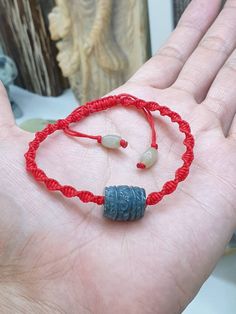 Beautiful, Etruscan-style, blue Jade barrel bead (13 mm x 15 mm) in handcrafted, adjustable Red Thread bracelet (done in spiral braiding). A pair of brownish yellow Jade barrel beads (6 mm x 9 mm) were used for adjusters. All Type A natural Jadeite (non -bleached, non-dyed, non-treated materials). Protection, good luck, good fortune, wealth, prosperity and long life. For customers with much bigger fist and wrist, you can send us a direct message immediately after your payment so we can customized the size before shipping. Price indicated is for 1 piece bracelet. Adjustable Carved Bracelets With Round Beads, Red Thread Bracelet, Brownish Yellow, Thread Bracelet, Blue Jade, Yellow Jade, Thread Bracelets, Red Thread, Braided Bracelet