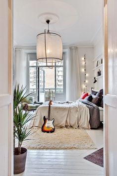 an open door leading to a bedroom with a guitar on the floor