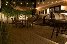 an outdoor patio with lights strung over it