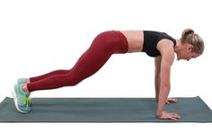 a woman doing push ups on a yoga mat