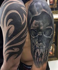 a man's half sleeve with a skull and two people on the inside of it