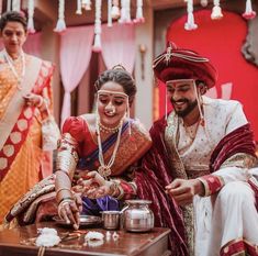 the bride and groom are getting ready for their hindu wedding ceremony in this candid photo