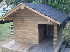 a dog house made out of wooden boards