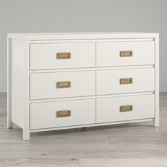 a white dresser sitting on top of a wooden floor