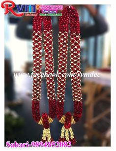 red and gold beaded necklaces hanging from the ceiling