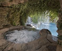 there is a waterfall in the middle of some rocks and water flowing from it's mouth