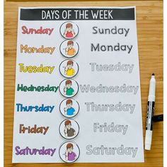 a days of the week poster on a wooden table with a marker and pen next to it