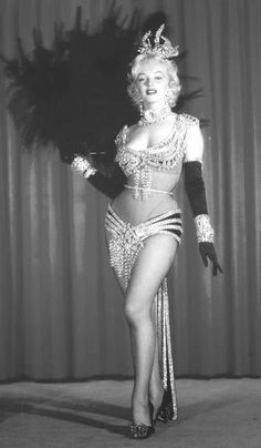 a black and white photo of a woman in costume