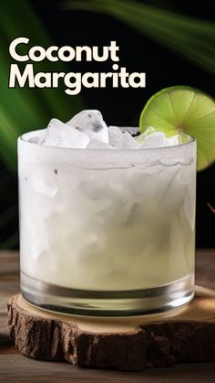 a close up of a drink in a glass on a table with the words coconut margarita