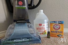 a carpet cleaner and cleaning supplies on the floor