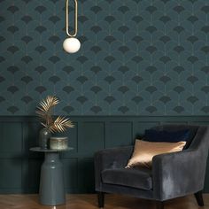 a chair and table in front of a wall with an art deco pattern on it