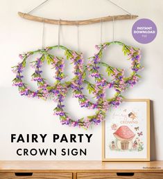 the cover of fairy party crown sign is hanging from a branch with purple flowers on it