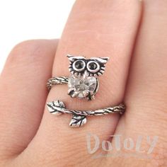 This adjustable ring is made with a band in the shape of a branch wrapped around your finger with a little baby owl on the end with rhinestone details! So cute and pretty! Size: Adjustable!Material: Tin Alloy, Rhinestones Store FAQ | Shipping Info | Returns & Exchanges Whimsical Adjustable Rings, Cute Adjustable Open Ring Jewelry, Cute Adjustable Nickel-free Rings, Adjustable Nickel-free Cute Rings, Adjustable Cute Nickel-free Rings, Owl On A Branch, Animal Ring, Baby Owl, Animal Rings