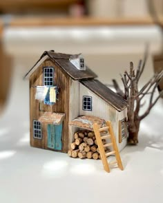 a miniature house made out of wood and logs