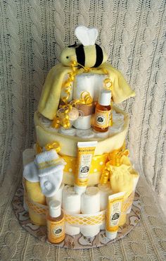 a cake made to look like a bee with lots of bees around it and baby items on top