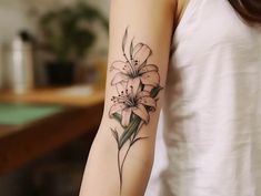 a woman's arm with a flower tattoo on the left side of her arm