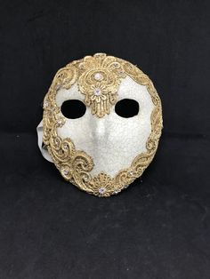 Full Face Moretta Mask. Size: one size Traditional and original papier-mache Venetian mask, handmade and decorated with burano macramè lace,gold leaf or silver leaf,and swarovski crystal. The mask has double paper mache. All our masks are handmade papier-machè masks made in Venice. Our decorators use techniques typical of the Venetian tradition such as stucco, acrylics, gold and silver-leaf, macramè, passementerie, pearls and crequelè to give you a wide range of masks. The mask could be slightly Traditional White Masks For Masquerade, Traditional White Mask For Carnival, Traditional White Masks For Carnival, Traditional White Carnival Mask, Traditional White Masquerade Mask For Carnival, White Venetian Masquerade Mask As Gift, White Venetian Masquerade Mask For Gift, Venetian White Full Face Mask, White Venetian Full Face Mask