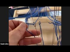 someone is working on something with blue thread