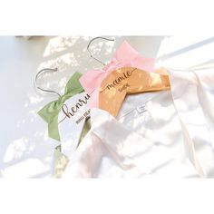 two bow tie hangers with name tags on them