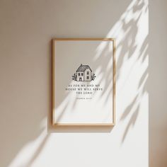 a framed print with the bible verse above it on a wall next to a potted plant