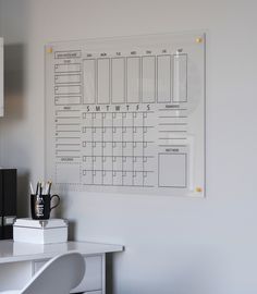 a white desk with a calendar on the wall