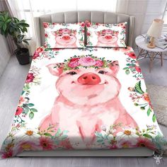 a pink pig with flowers on it's head is shown in this bedding set