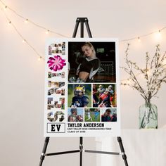 an easel with a poster on it in front of a string of lights