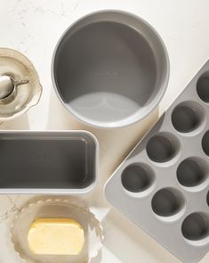 three pans and one cupcake tin on a counter