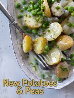 a bowl filled with potatoes and peas on top of a white table next to a fork