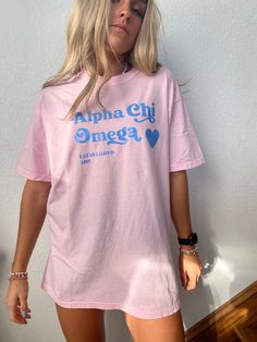 This is a Comfort Colors T-Shirt. The color of the shirt is blossom (light pink), with sky blue lettering. Sizes available as Small-Large. Fit is slightly oversized. Please message me with any questions! Cheap Sorority Summer T-shirt, Pink Short Sleeve T-shirt For College, Pink Graphic Print T-shirt For College, College Pink Graphic Print T-shirt, Cute Spring College T-shirt, Pink Graphic Tee For College, Pink T-shirt With Name Print For Summer, Pink Sorority T-shirt With Crew Neck, Casual Pink T-shirt For College