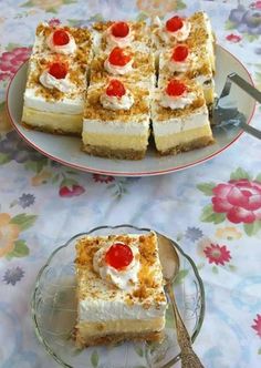 there are several pieces of cake on the plate and one slice has cherries on it