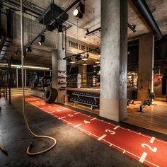 an indoor gym with treading and exercise equipment on the floor in front of it