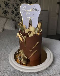 a birthday cake decorated with chocolate and gold decorations