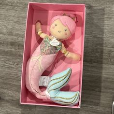 a pink mermaid doll in a pink box