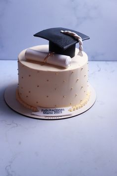 a cake with a graduation cap and tassel on top