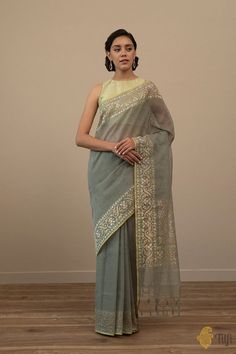 Lekha - This exquisite Jamdani saree is a woven dream. Crafted in zari made of pure Silver and spun like poetry in an enchanting shade. A plain body set against beautiful pure zari borders and adorned with the finest corner paisleys, all with delicate meenakari hues, this saree brings the best of Banarasi weaving traditions. Wire Weaving, Pure Cotton, Borders, Paisley, Poetry