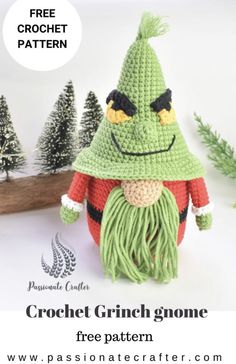 a crocheted gnome with long green hair and black eyes is shown in front of pine trees