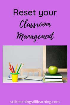 a desk with an apple, books and pencils on it in front of a chalkboard